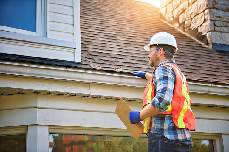 Contractor inspecting house roof